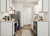 Thumbnail 13 of 74 - A modern kitchen with white cabinets and appliances.