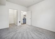 Thumbnail 20 of 46 - A room with a carpeted floor and white walls.