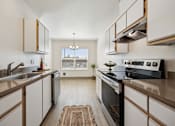 Thumbnail 49 of 74 - A modern kitchen with a black oven and wooden cabinets.