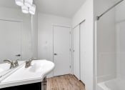 Thumbnail 35 of 44 - a bathroom with a sink and a bathtub