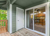 Thumbnail 50 of 66 - A white door and sliding glass window on a porch.