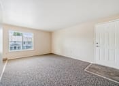 Thumbnail 17 of 35 - Empty room with a door and a window.