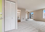 Thumbnail 21 of 31 - A room with a white door and carpeted floor.