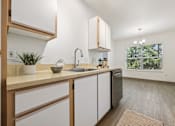 Thumbnail 17 of 74 - A kitchen with white cabinets and a wooden counter.