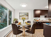Thumbnail 22 of 44 - A dining room with a table set for four.