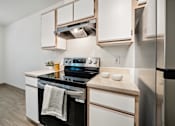 Thumbnail 18 of 74 - A modern kitchen with a stove, oven, and refrigerator.