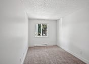 Thumbnail 28 of 44 - A room with a window and a carpeted floor.