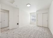 Thumbnail 19 of 74 - A spacious room with carpeted floor and white walls.