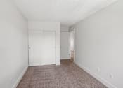 Thumbnail 30 of 44 - A room with carpeted floor and white walls.