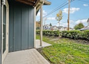 Thumbnail 26 of 46 - A green wooden garage door with a white door handle.