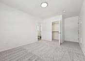 Thumbnail 54 of 74 - A room with a carpeted floor and a ceiling light.