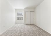Thumbnail 20 of 74 - A room with a carpeted floor and a door.