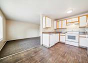 Thumbnail 16 of 25 - A kitchen with white cabinets and a white oven.