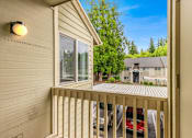 Thumbnail 23 of 36 - A balcony with a red car parked in the driveway.