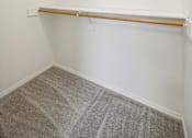 Thumbnail 55 of 74 - A white wall with a shelf and a carpeted floor.