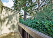 Thumbnail 32 of 44 - A wooden deck with a white door and a wooden railing.