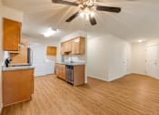 Thumbnail 23 of 66 - Cascade Woods living area with kitchen and ceiling fan in view
