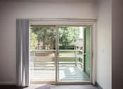 Thumbnail 34 of 40 - A view of a backyard through a sliding glass door.