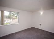 Thumbnail 32 of 40 - A room with a window and a ceiling light.