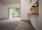 Thumbnail 40 of 40 - A room with a grey carpet and a white wall with a window.