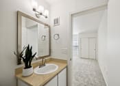 Thumbnail 24 of 74 - A bathroom with a sink and mirror.