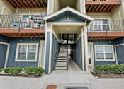 Thumbnail 6 of 46 - A building with a staircase leading to the entrance.