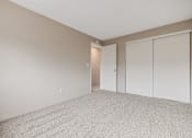 Thumbnail 29 of 31 - A room with a carpeted floor and a white door.