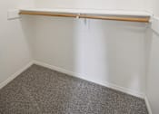 Thumbnail 60 of 74 - A white wall with a shelf and a grey carpet.