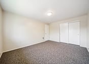 Thumbnail 28 of 35 - A room with a carpeted floor and a white ceiling.
