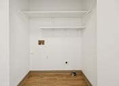 Thumbnail 30 of 74 - A room with a wooden floor and a picture frame on the wall.
