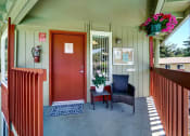 Thumbnail 8 of 44 - a front porch with a red door and two chairs