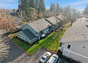 Thumbnail 32 of 37 - A house with a grey roof and a red border around the driveway.