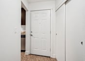Thumbnail 10 of 44 - A white door is in a hallway with a light switch on the wall.