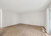 Thumbnail 11 of 44 - A room with wooden flooring and white walls.