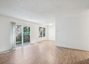 Thumbnail 13 of 44 - A room with wooden floors and white walls.