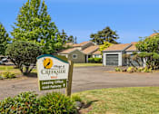 Thumbnail 1 of 40 - A sign for the Village at Creekside leasing office is in front of a building.