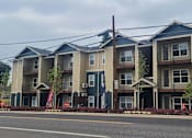 Thumbnail 31 of 46 - Apartment building with multiple balconies and doors.