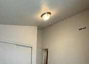 Thumbnail 15 of 18 - A room with a carpeted floor and a white door.