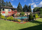 Thumbnail 42 of 44 - a yard with a pool and a house with a fence