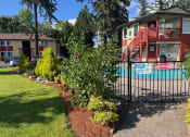 Thumbnail 41 of 44 - a house with a pool and a fence in front of it