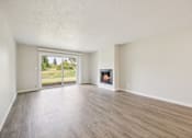 Thumbnail 17 of 40 - A room with a fireplace and sliding glass doors.