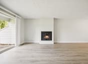 Thumbnail 18 of 40 - A modern living room with a fireplace and a sliding glass door.