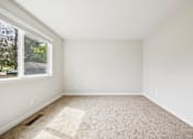 Thumbnail 36 of 40 - A room with a carpeted floor and a window.