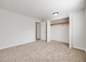 Thumbnail 37 of 40 - A room with a carpeted floor and white walls.