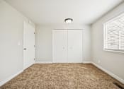 Thumbnail 38 of 40 - A room with carpeted floor and white walls.