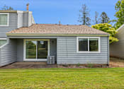 Thumbnail 4 of 40 - A house with a grey siding and a brown roof.