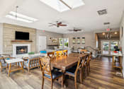 Thumbnail 16 of 40 - A dining room with a wooden table and chairs.