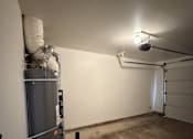 Thumbnail 17 of 18 - A room with a water heater and pipes.