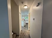 Thumbnail 11 of 56 - A hallway with a carpeted floor and a light on the ceiling.