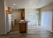 Thumbnail 4 of 18 - A kitchen with a refrigerator, dishwasher, and sink.